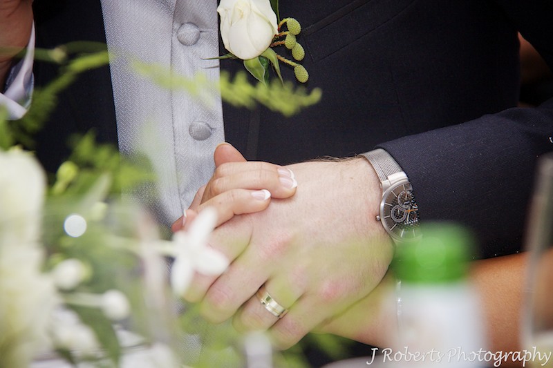Couple holding hands during speeches - wedding photography sydney